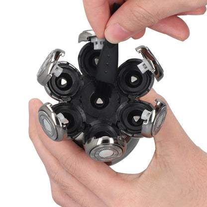 Multiple Aeqis 6 in 1 Shaving head held in a hand against a white background