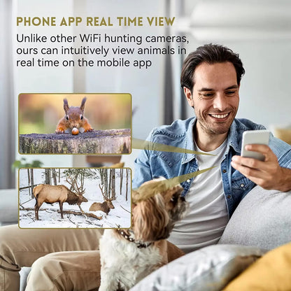 Man sitting on a couch with a dog, using a phone app to view animals in real time.