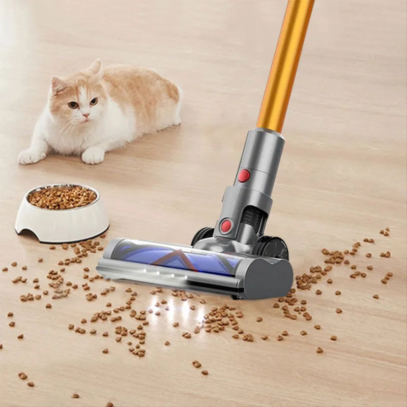 Auralink Vacuum Cleaner up pet food on a wooden floor with a cat observing.