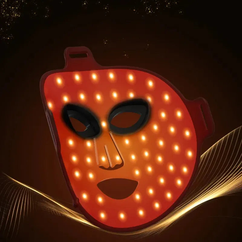 Aureline AureGlow Face LED Mask with glowing orange lights on a dark background