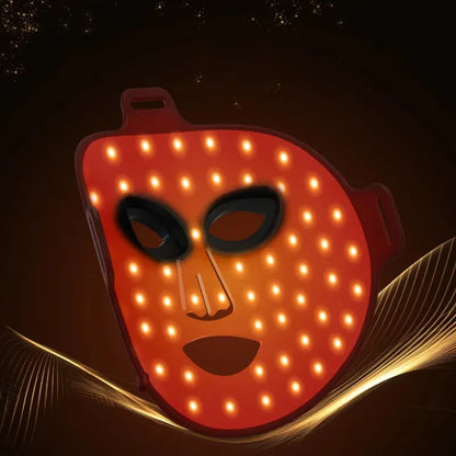 Aureline AureGlow Face LED Mask with glowing orange lights on a dark background