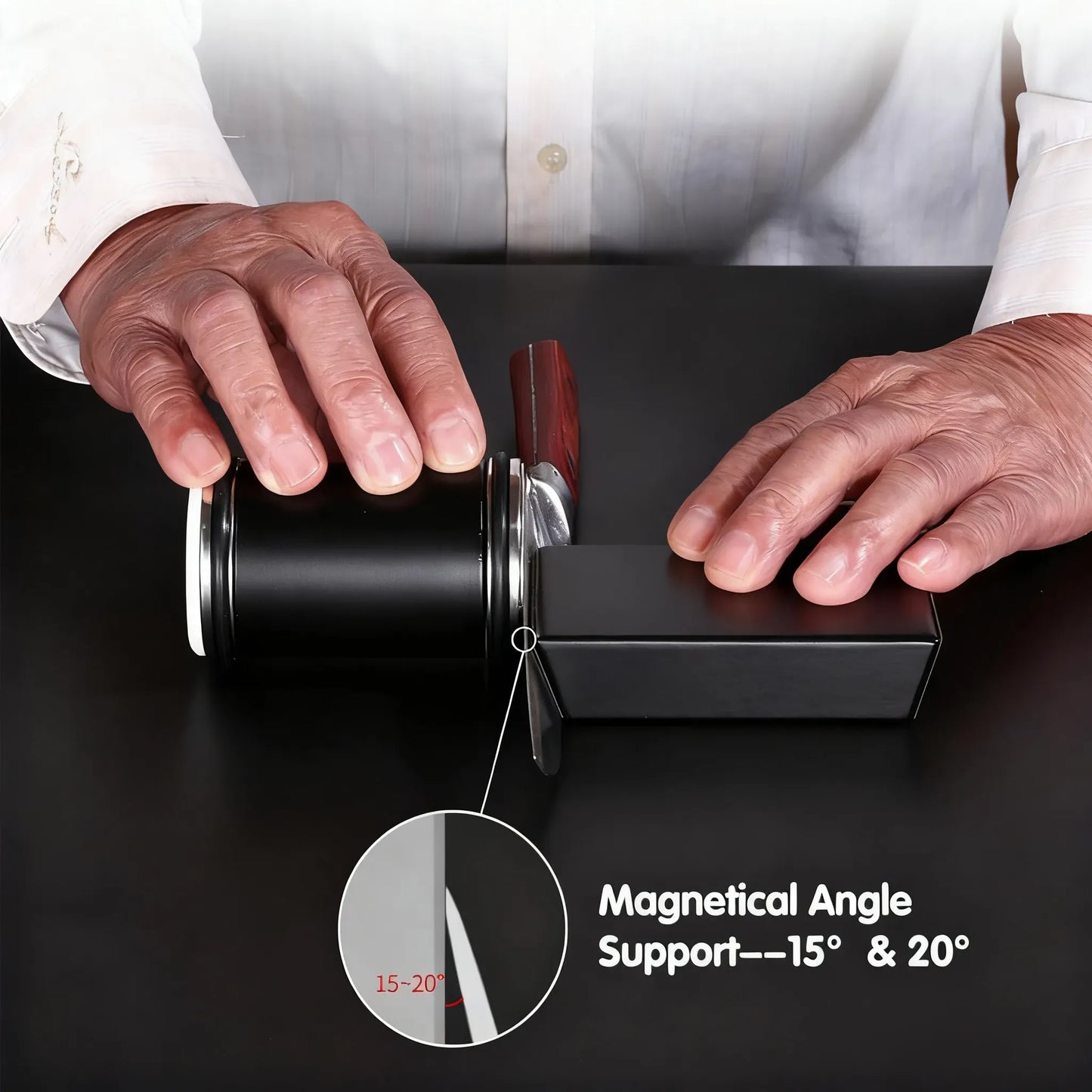 A close-up of a person's hands demonstrating a black cylindrical magnetic knife block on a dark surface, with a circular inset showing a 15-20 degree angle and text reading 'Magnetic Angle Support---15° & 20°'.