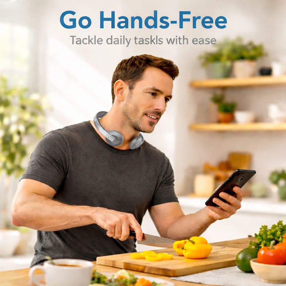 A man in a kitchen wearing a gray neck massager around his neck, holding a smartphone and slicing yellow bell peppers on a wooden cutting board. The text at the top reads 'Go Hands-Free'.