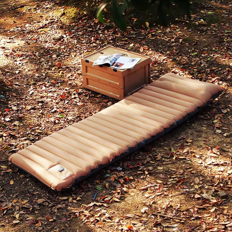 Inflatable CapixMat Camping Mattress on the ground with a wooden crate and books in the background.