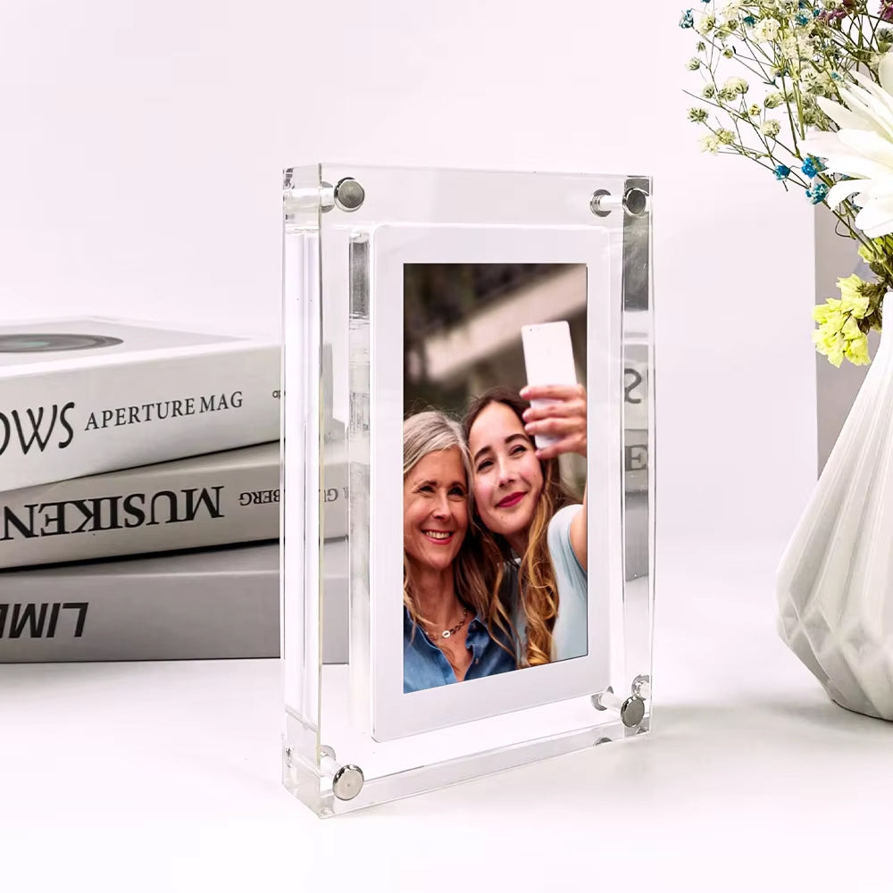 Clear CaptiPix Digital Photo Frame with a picture of two women on a white surface.