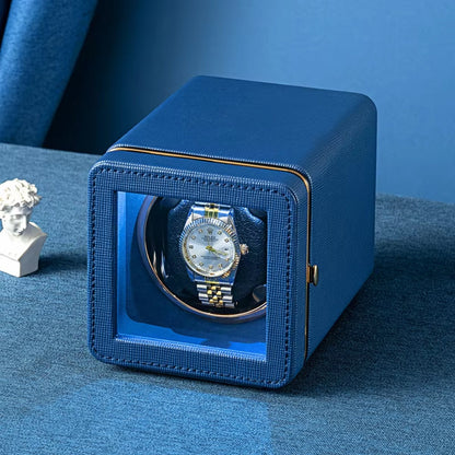 Blue ChroniNova Watch Winder with a watch inside on a blue surface