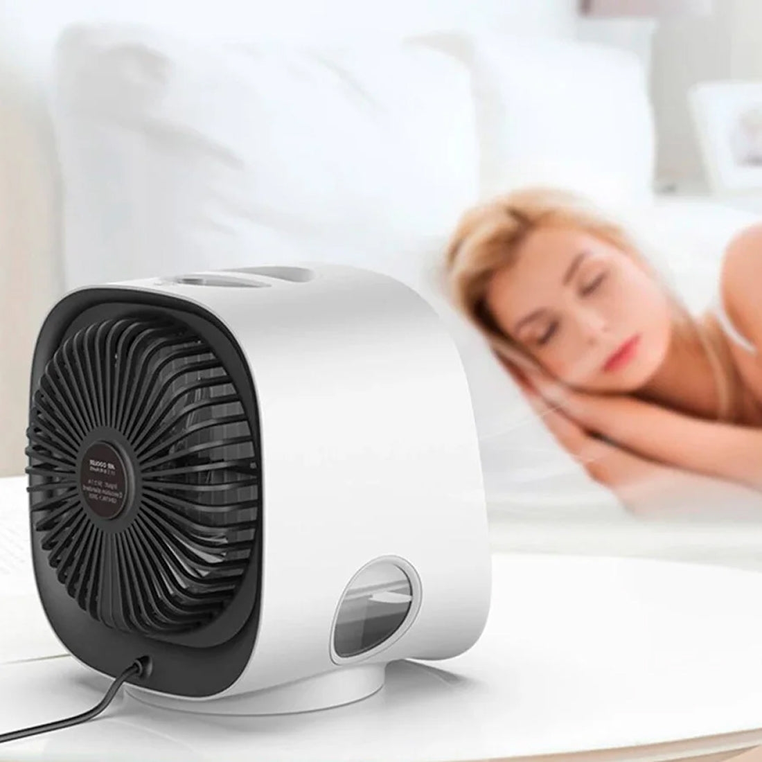 Coolevax Portable Air Conditioner on a surface with a blurred background of a person lying down.