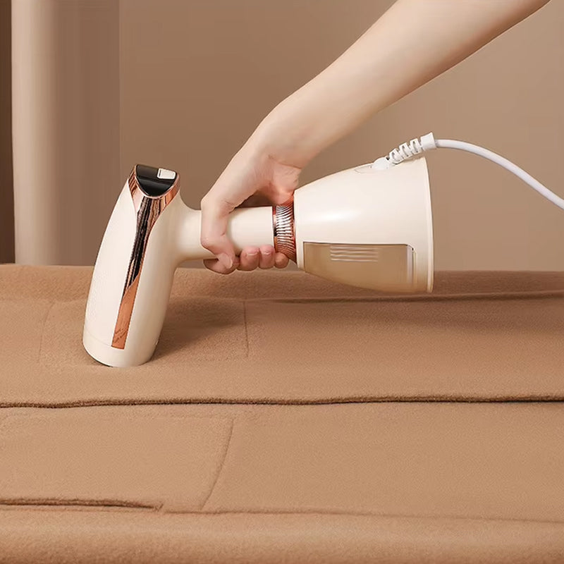 Hand holding a white CriisMist Handheld Steamer cleaner on a brown surface.