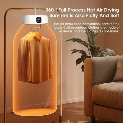 DryTekco Foldable Dryer with clothes inside, placed in a room with a couch and plant.
