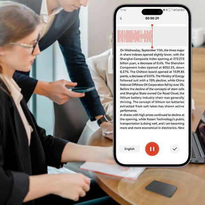 Person using a smartphone with a translation app displayed on a screen, showing text being translated.