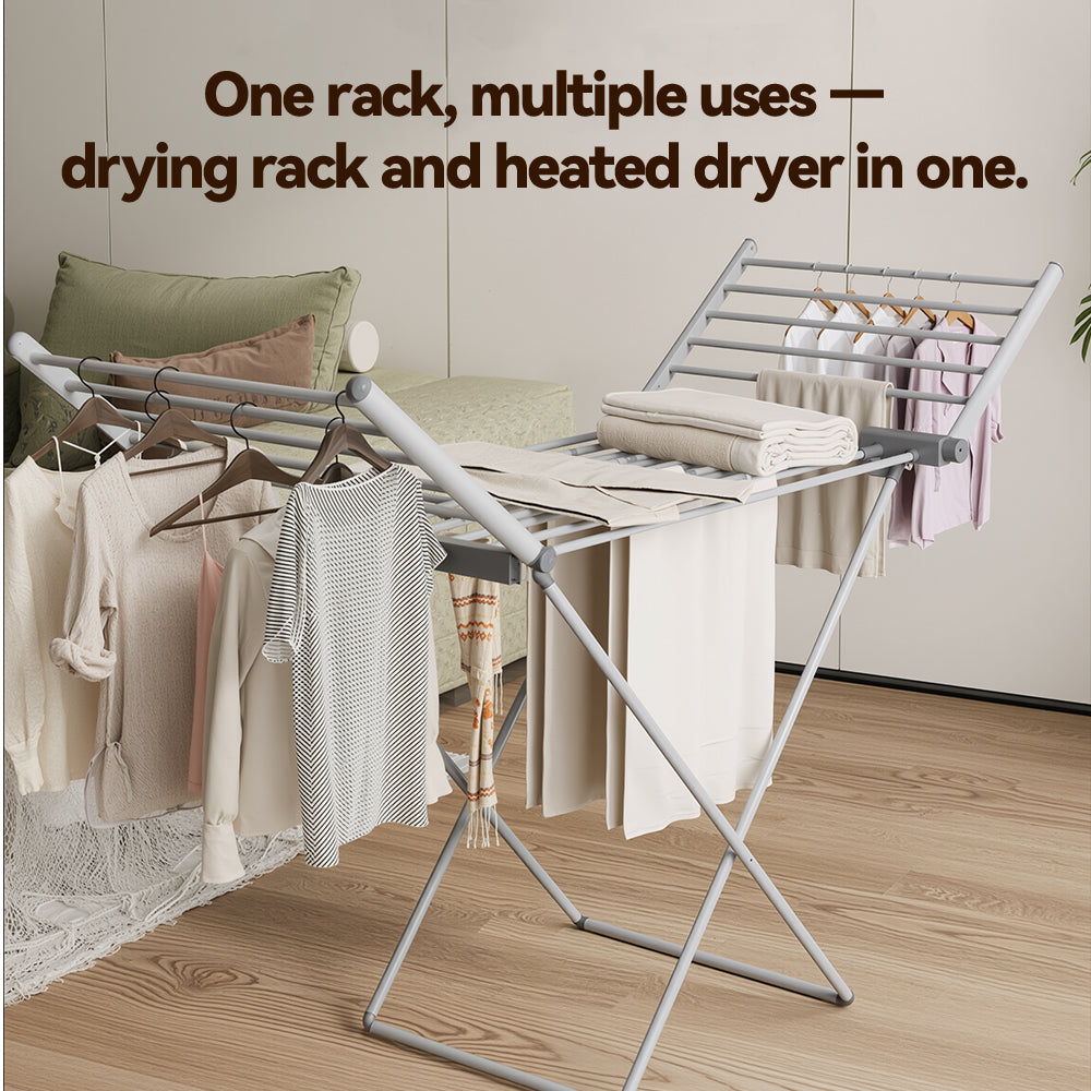 A silver metal Elarvo Heated Clothes Airer rack shown in a styled room setting with folded and hanging towels and garments. Text at the top reads, 'One rack, multiple uses — drying rack and heated dryer in one.