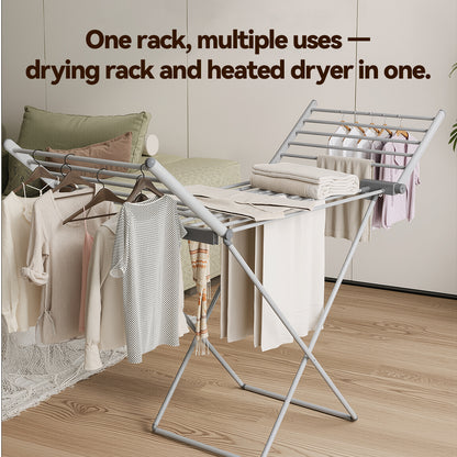 A silver metal Elarvo Heated Clothes Airer rack shown in a styled room setting with folded and hanging towels and garments. Text at the top reads, 'One rack, multiple uses — drying rack and heated dryer in one.