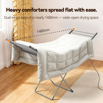 An Elarvo Heated Clothes Airer shown in a room setting with wooden floors and a yellow curtain, featuring text overlays explaining its wide 1480mm drying space.