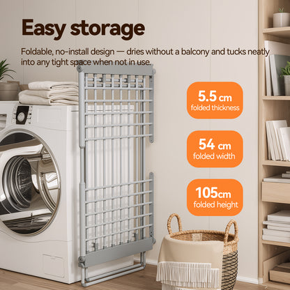 A Elarvo Heated Clothes Airer laundry storage gate shown installed beside a washing machine in a bright room, with text callouts reading 'Easy storage' and dimensions: 5.5 cm folded thickness, 54 cm folded width, and 105 cm folded height.