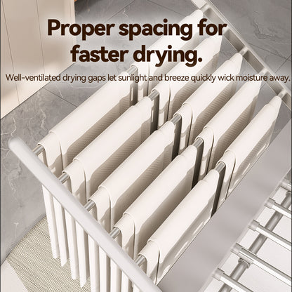 A close-up of a white fabric Elarvo Heated Clothes Airer sheet or towel draped over a white radiator in a bathroom setting, with overlaid text explaining proper spacing for faster drying.