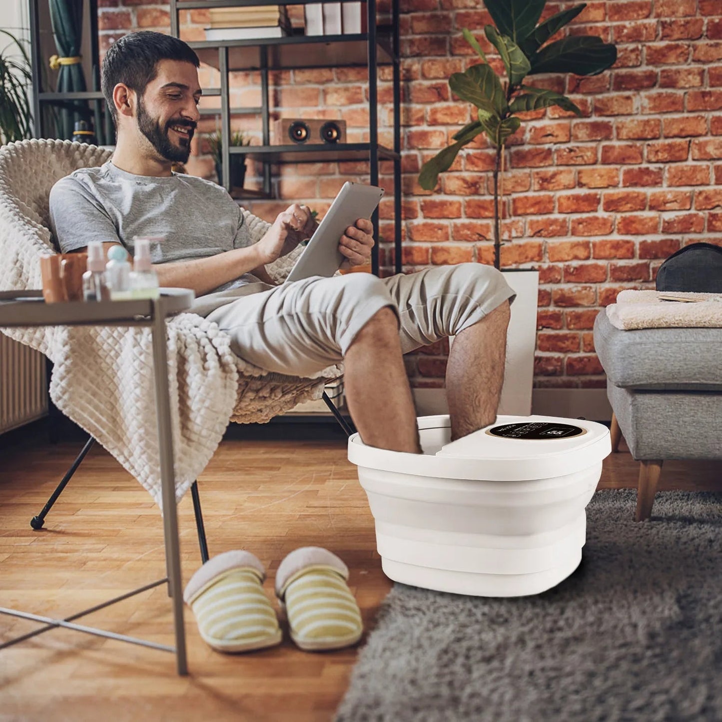 Man using a FotixBath Foot Bath in a cozy living room.