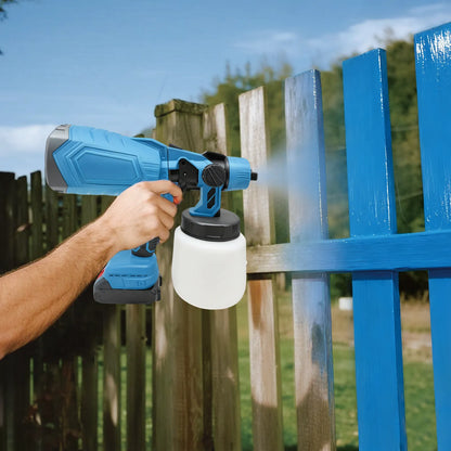 Person using a blue Geekik Cordless Paint Sprayer to paint a wooden fence.