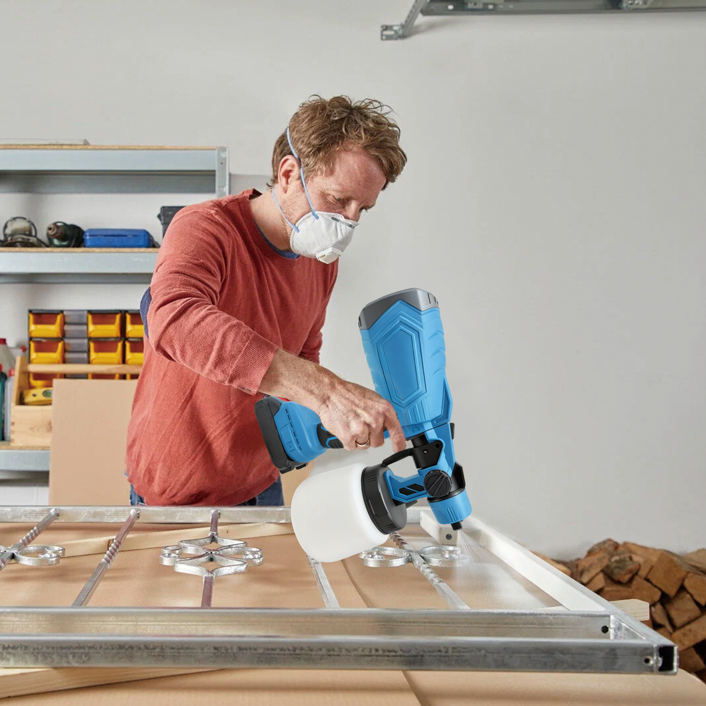 Man using a Geekik Cordless Paint Sprayer on a wooden frame in a workshop.