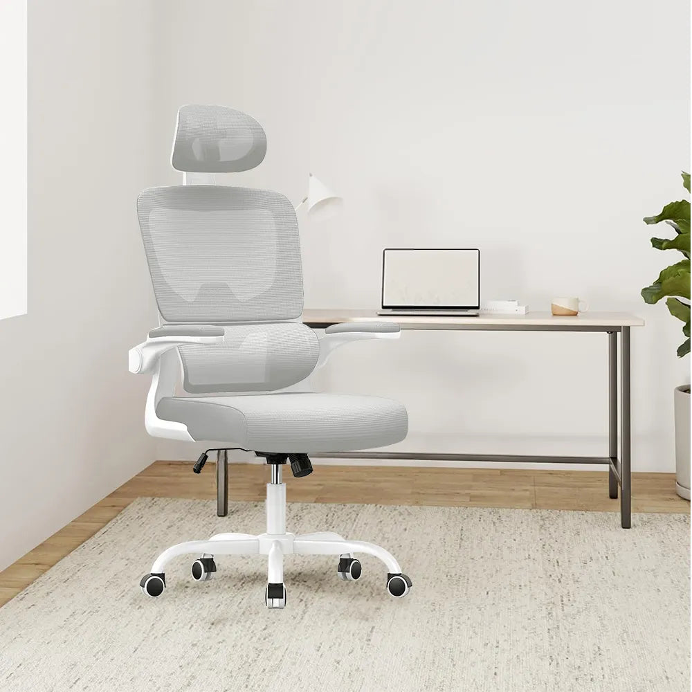 White Kalvori Ergonomic Office Chair in a minimalistic room with a desk and laptop.