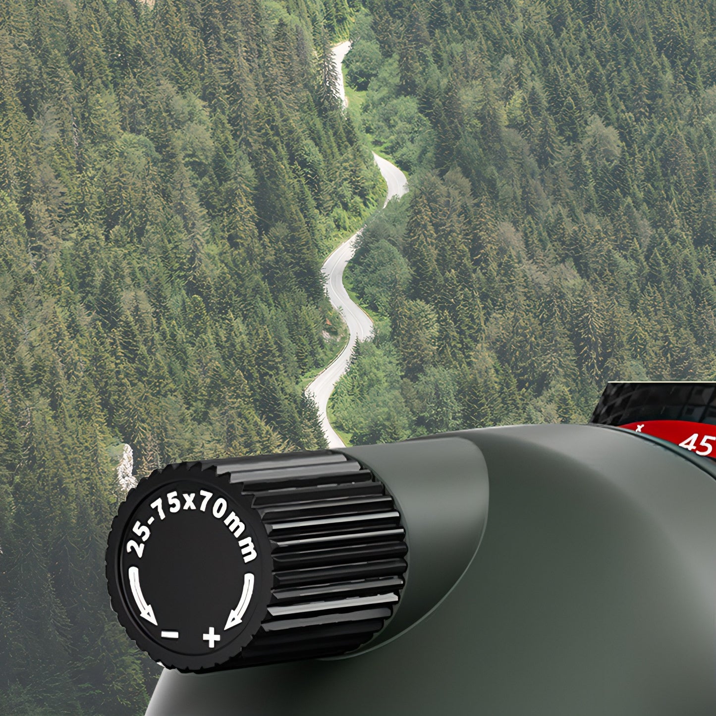 Keovy Spotting Scope lens with focus ring against a scenic background of trees and a river