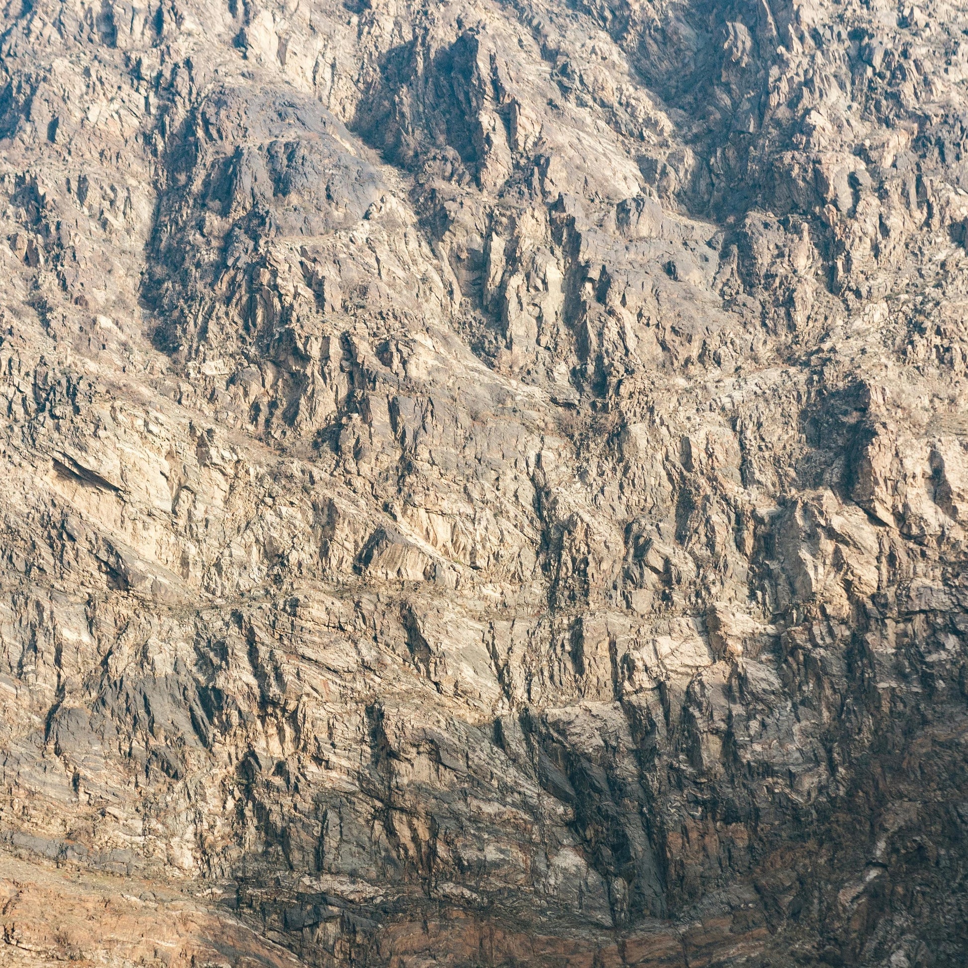 Rough, textured surface resembling a mountain or rock wall.