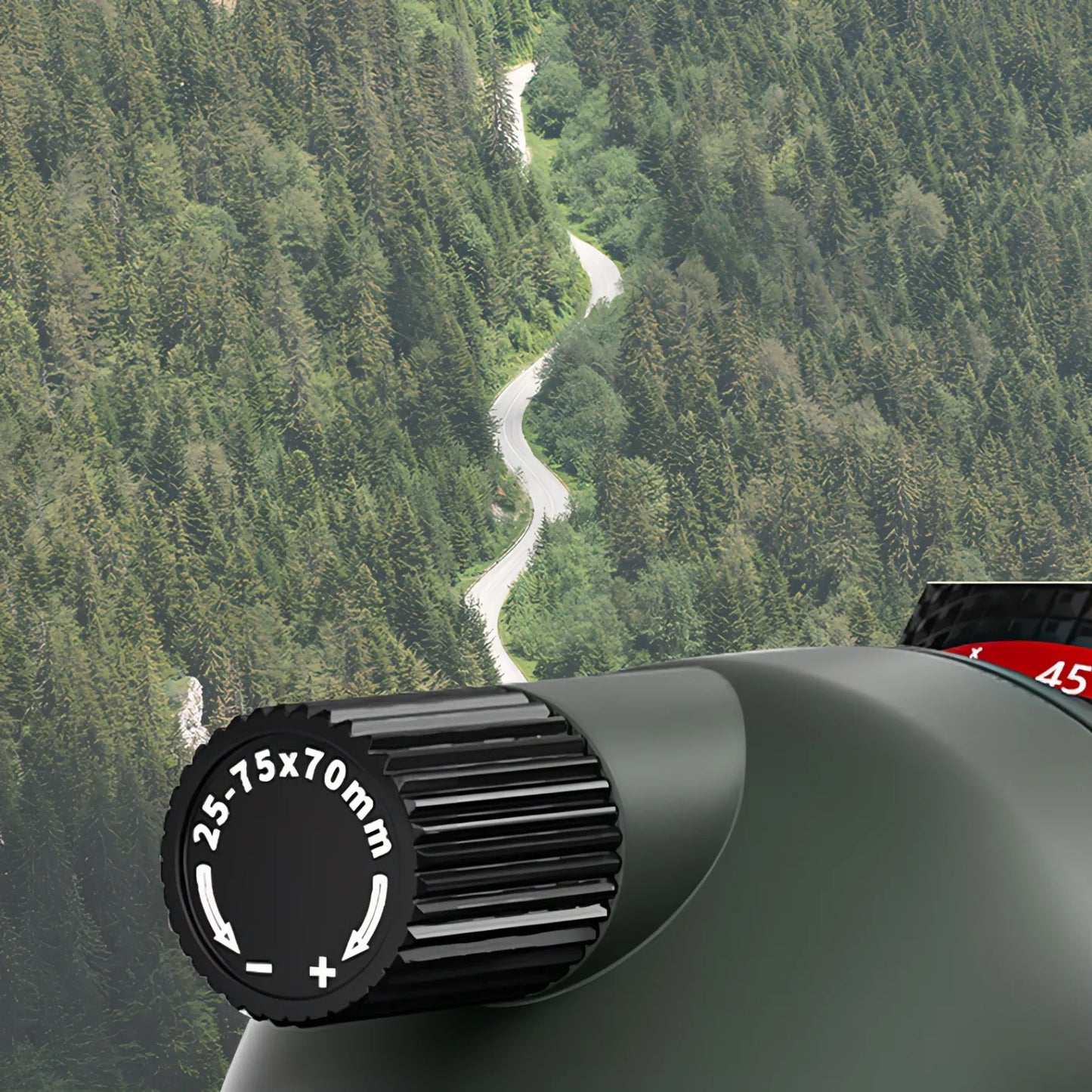 Korons Spotting Scope lens with focus ring on a mountainous landscape background