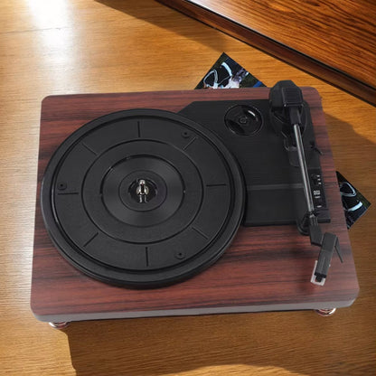 MelooDisc Record Player with black turntable on a wooden surface