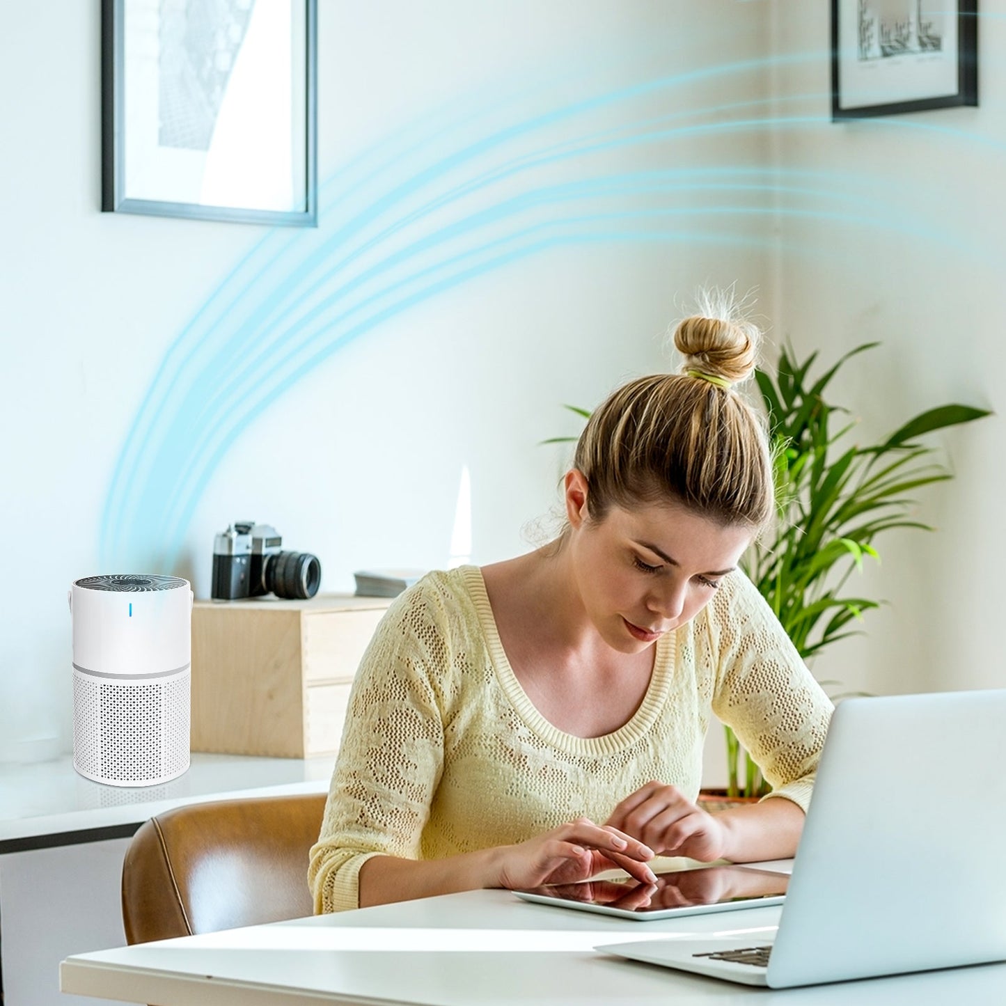 Woman using a laptop with an Mivrass Air Purifier in the background