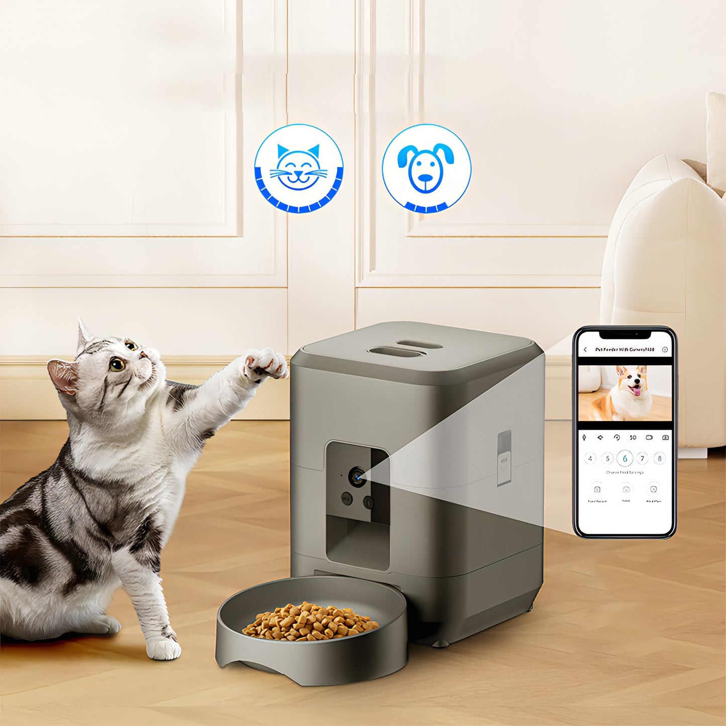 Cat interacting with a Moravon Pet Feeder on a wooden floor, with an app displayed on a smartphone.