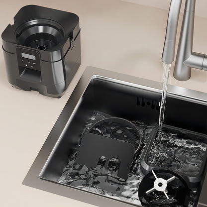 Blender base being rinsed in a sink with running water, next to a kitchen faucet.