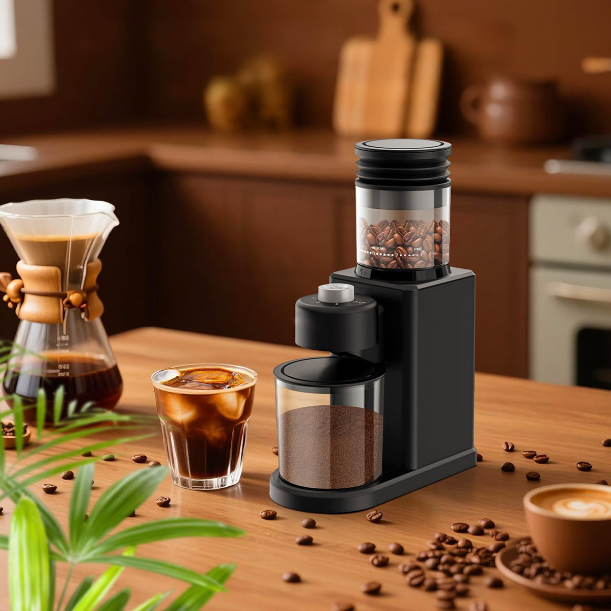 A black countertop NeadGrint Espresso Grinder with a clear bean hopper and clear ground-coffee container, shown on a wooden kitchen counter beside a pour-over coffee maker, iced coffee, and scattered coffee beans.