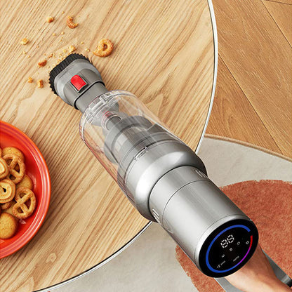 Handheld Noventrixa Vacuum Cleaner on a wooden floor with food debris