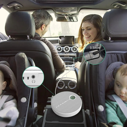 Family in a car with a device on the dashboard, likely a car air freshener or organizer.
