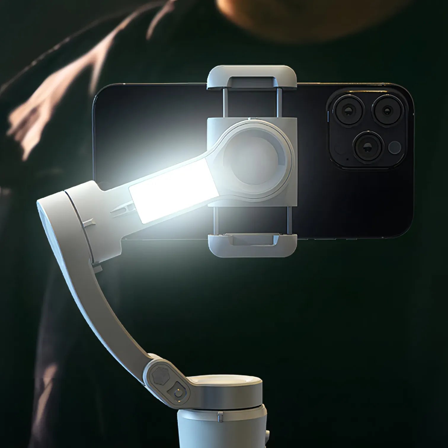 Smartphone with a mounted light and Optego Gimbal on a dark background