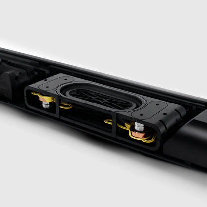 Close-up of a black electronic Rivelia Wireless Soundbar with visible components on a white background