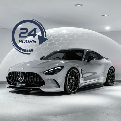White Mercedes-Benz car in a showroom with a 24-hour service icon.