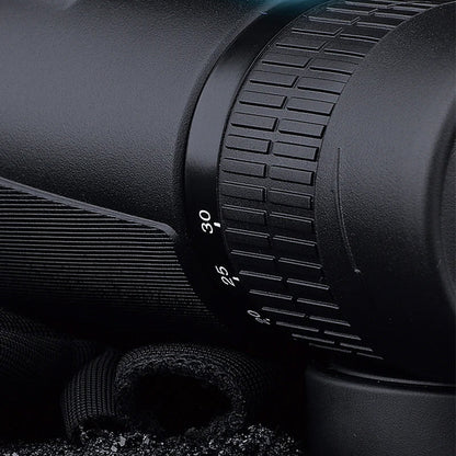 Close-up of a black rifle scope with focus ring details