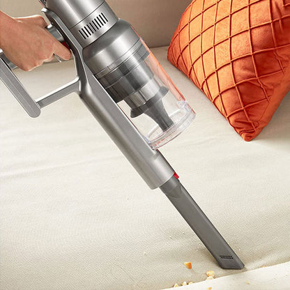 Handheld Starpod Vacuum Cleaner a surface with an orange pillow in the background