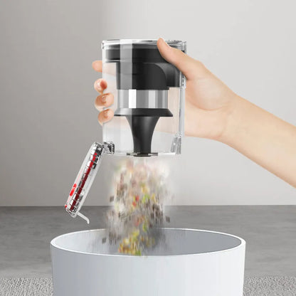 Hand using a Starpod Vacuum Cleaner to sprinkle pepper into a white container on a neutral background