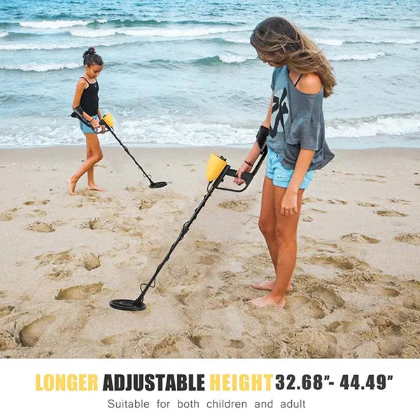 Two people using TeroTera Metal Detector on a beach with ocean waves in the background.