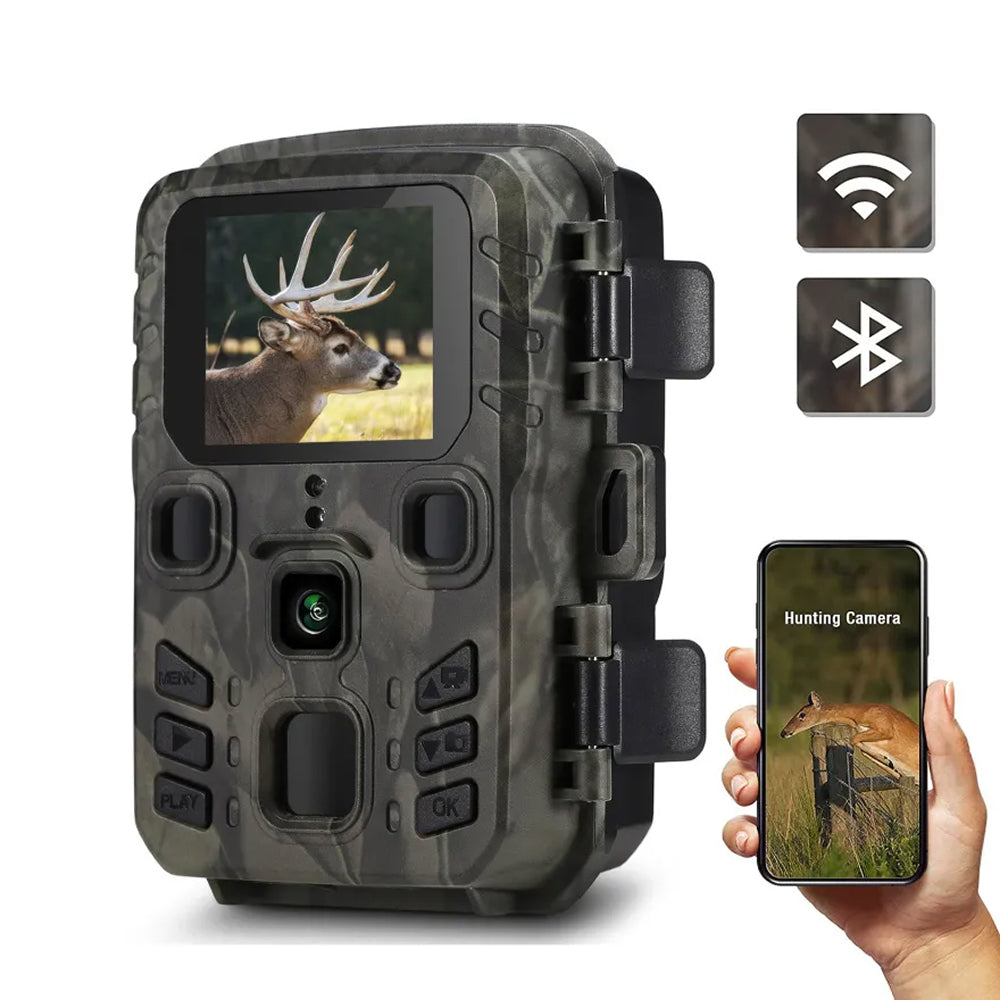 Camouflage TrackaPix Wildlife Camera with screen displaying a deer image, held by a hand with a smartphone showing the same image.