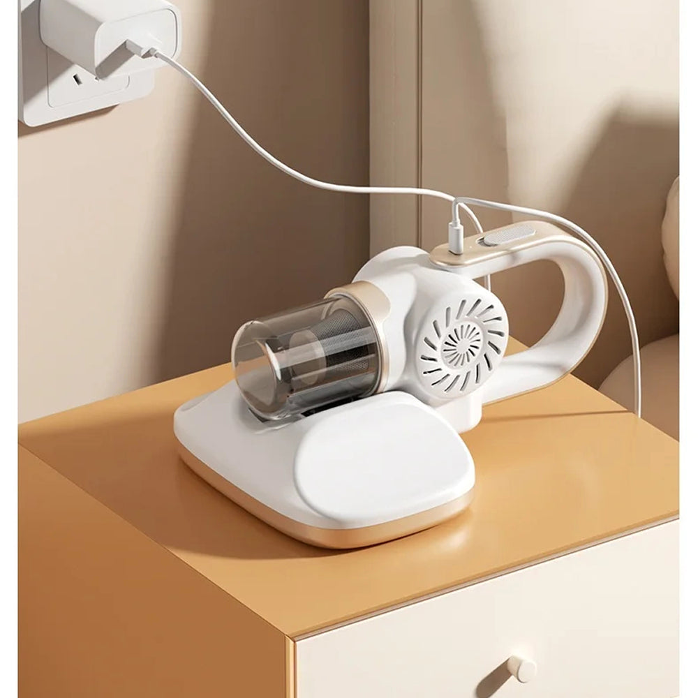 Handheld VaciMatri Mattress Vacuum Cleaner with glass container on a wooden surface