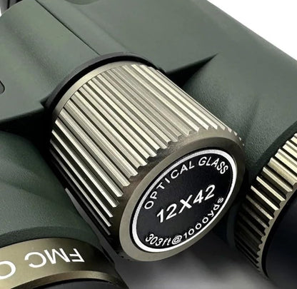 Close-up of a 12x42 Valisus Binoculars lens with 'FMC' branding on a white background.