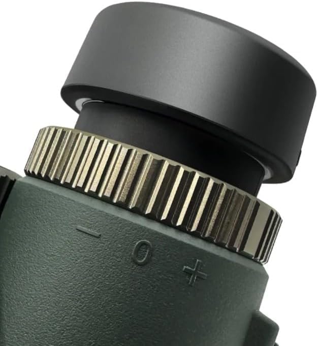 Close-up of a black and green Valisus Binoculars lens with a focus wheel on a white background