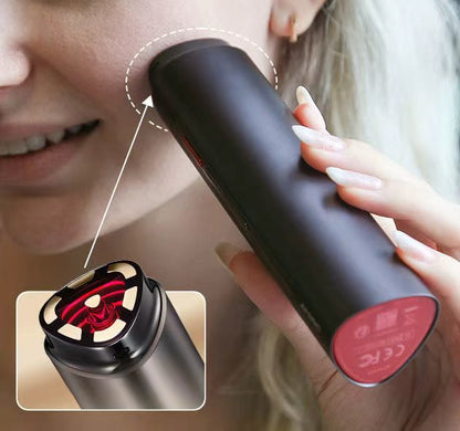 Black Vellera S1 Pro Facial Skin Tightening Device with red accents held by a person, close-up of device's interior.