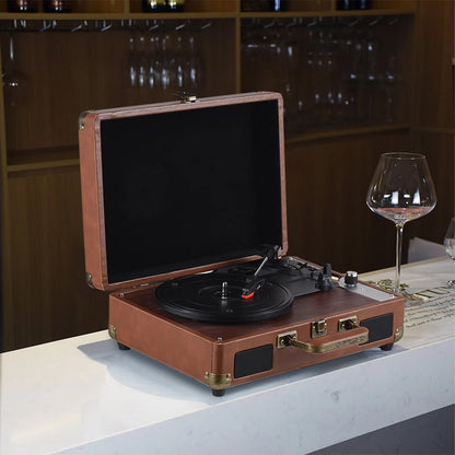 Vintage-style brown Vinixora Record Player on a table with wine glasses in the background