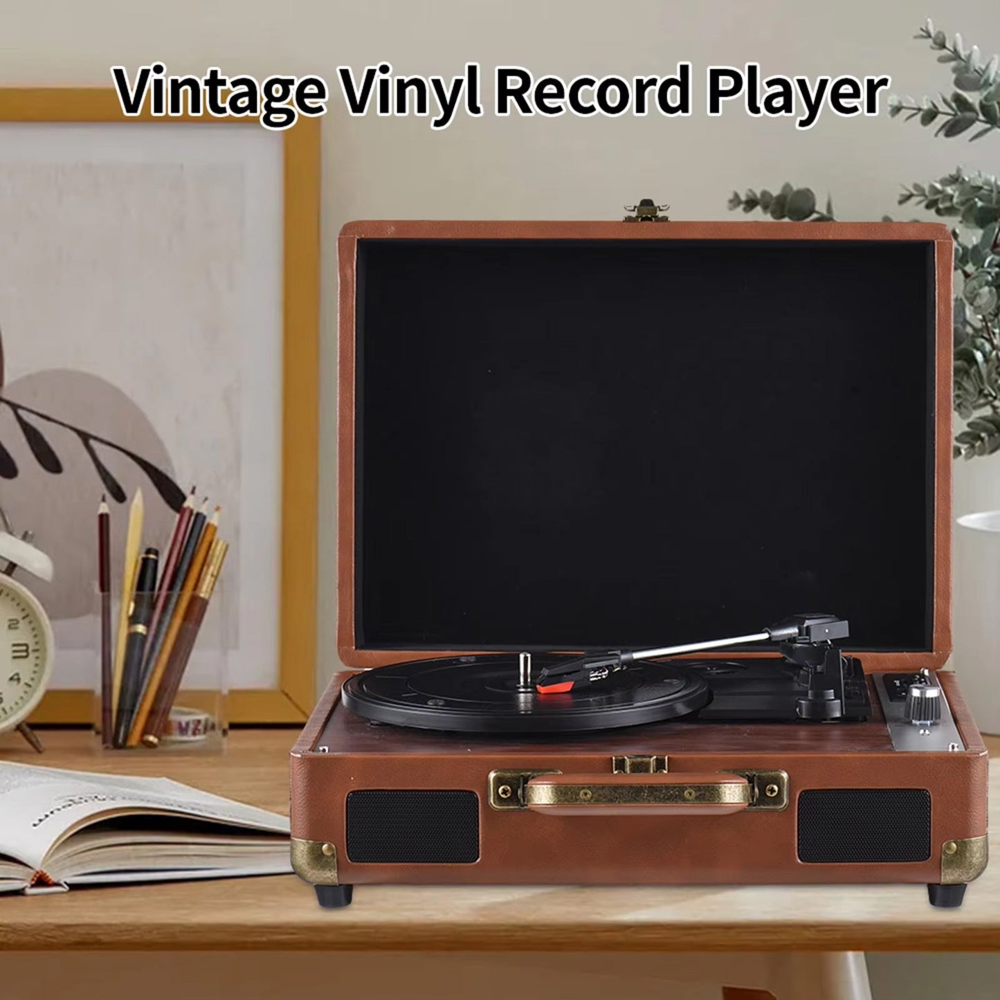 Vintage vinyl Vinixora Record Player on a desk with stationery items and a plant in the background.