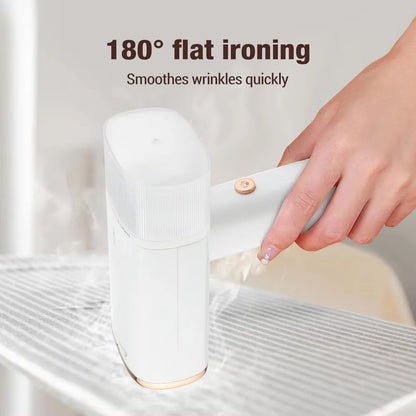 Hand using a white handheld WandixStim Steamer to smooth wrinkles on a piece of fabric with text '180° flat ironing' and 'Smothers wrinkles quickly'.