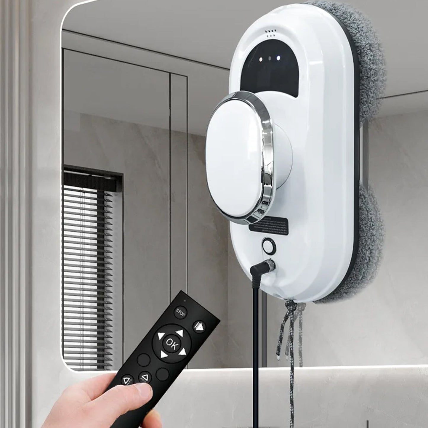 WiniGlide Robot Window Cleaner with remote control attached to a mirror