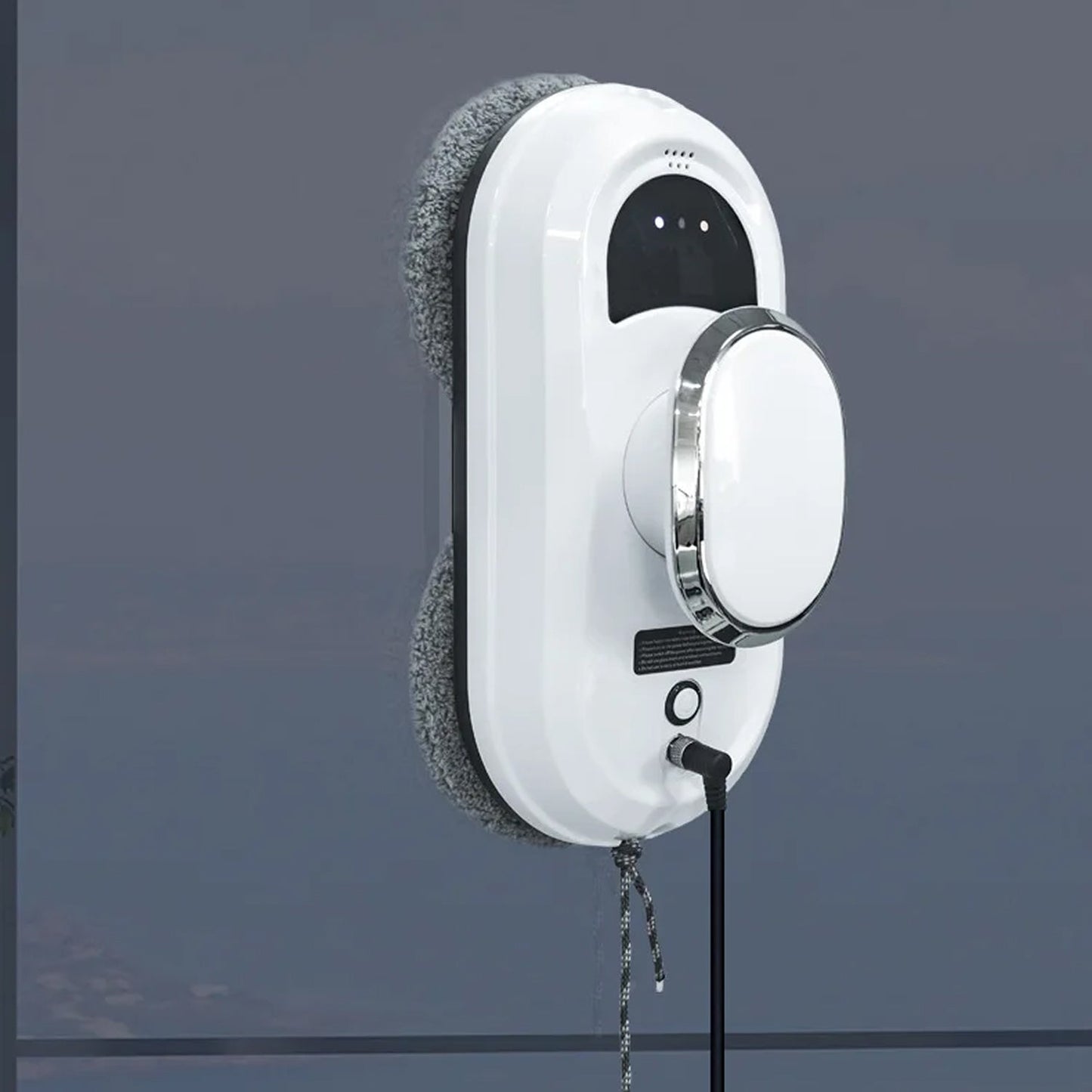 White WinoBotto Robot Window Cleaner with a cord on a dark gray background
